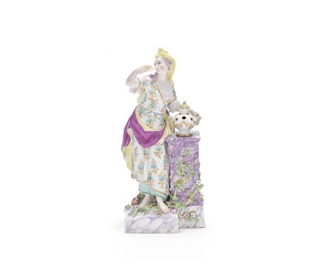 A Chelsea figure of Flora, circa 1765Modelled standing wearing a yellow headdress, purple and yellow cloak, and floral robes,