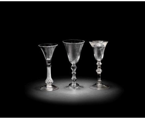 A composite-stem wine glass and two light baluster glasses, circa 1750-60The composite-stem glass with a lipped trumpet bowl 