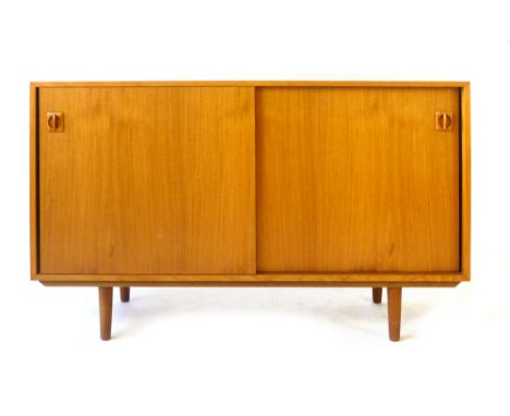 A Danish teak sideboard, the two sliding doors enclosing two shelves, l. 121 cm CONDITION REPORT: Possibly had another piece 