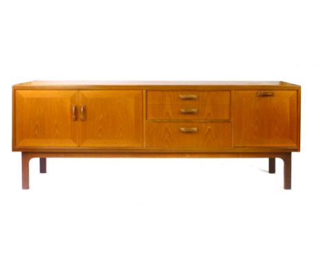 A 1970's teak sideboard, the three drawers flanked by a fall-front cupboard and two doors, on a sleigh-type base, l. 206 cm C