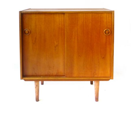 A Danish teak sideboard, the two sliding doors enclosing a single shelf, on tapering feet, l. 80 cm CONDITION REPORT: Wear co