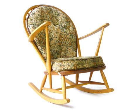 An Ercol beech and elm rocking chair with loose cushions CONDITION REPORT: No obvious splits to bentwood rail, worn, overall 