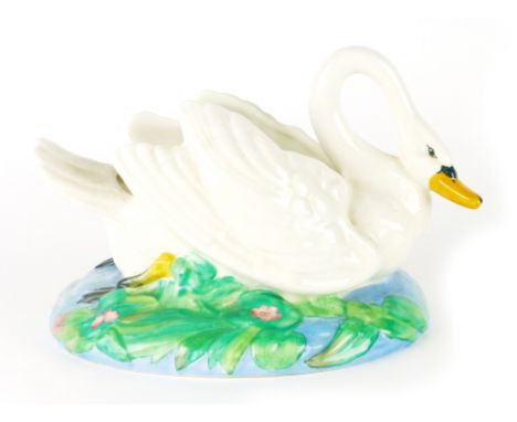 Clarice Cliff for Wilkinson, a table centre in the form of a swan seated on a lily pad, w. 29 cm CONDITION REPORT: No obvious