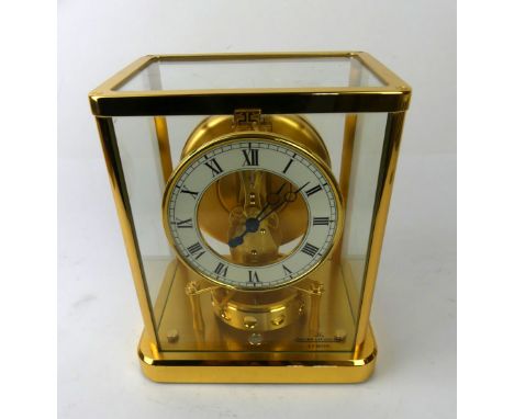 A Gilt brass Jaeger LeCoultre Atmos clockWith circular enamelled dial with Roman numerals, height of case 23cm   CONDITION RE