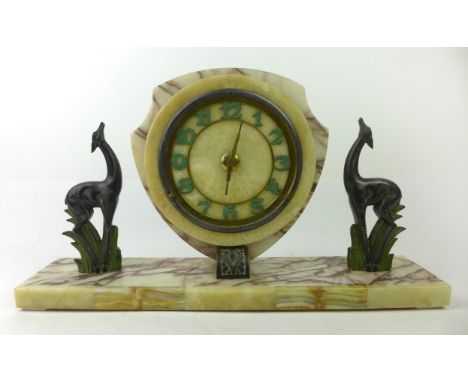 An Art Deco veined marble and spelter figural mantle clockModelled with circular clock flanked by two spelter antelopes, heig