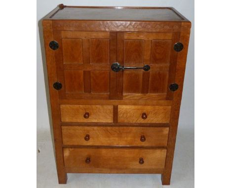 A Robert Mouseman Thompson oak tallboy With cupboard doors above two short over two long drawers, with carved mouse to corner