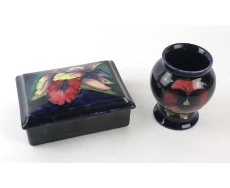 Two pieces of Walter Moorcroft To include a lidded trinket box decorated in the Orchid pattern on a blue ground, impressed si