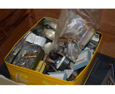 A tin containing various costume jewellery; silver plated cutlery; various craft tools; various white metal items