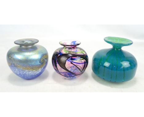 A Norman Stewart Clarke iridescent squat baluster vase, height 11cm, a further stained glass example and an unmarked example 