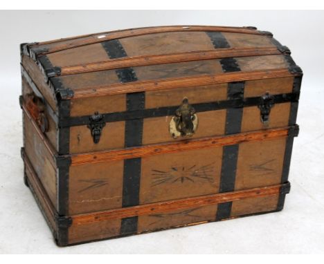 A vintage dome topped strap bound trunk.