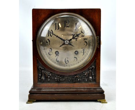 H PIDDUCK & SONS OF HANLEY; an Edwardian chiming mantel clock, the circular silvered dial set with Arabic numerals above carv