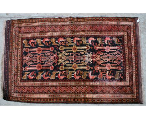 An Afghan Belouch rug with central medallion set with various stylised bids within a multi-step stylised border, 161 x 102cm.