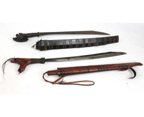 Two parangs, one with stylised carved pommel and both with wooden grips (the other af), blade length of each approx 51cm, bot