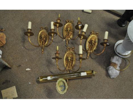 A set of four brass twin branch wall light with ram head decoration, length 27cm, and a further light fitting (5).