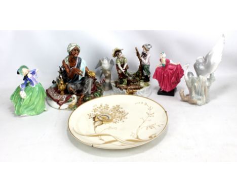 A group of ceramic figures including a Capodimonte street seller, a Nao figure group of herons and a Royal Doulton figure HN1