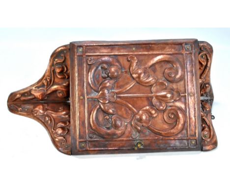 A small Arts and Crafts beaten copper mounted foliate motif corner cupboard with door enclosing single shelf, 55 x 25.5cm.