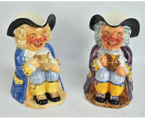 CLARICE CLIFF; two large Toby jugs with purple and blue coloured coats, both with Wilkinson Ltd stamps to base, height of eac