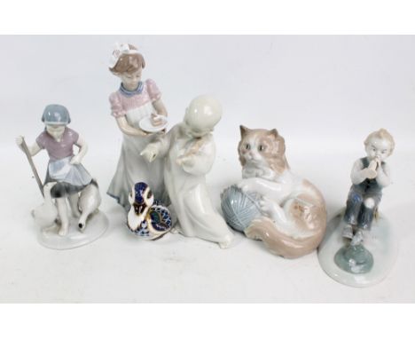 Two Lladro figures comprising a girl carrying a piece of cake, and a cherubic violinist (af), a Nao figure of a kitten with b