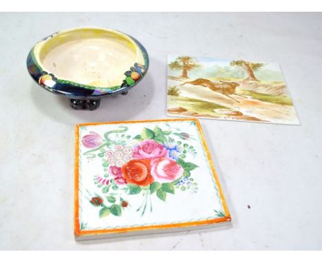 A Wilkinson Ltd iridescent glazed bowl, a floral painted butcher's square and a tile painted with a hare (3).