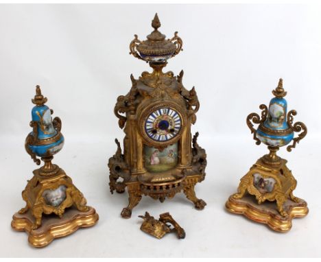 A French gilt metal mantel clock with porcelain urn above hand painted circular dial set with Roman numerals and a figural ga