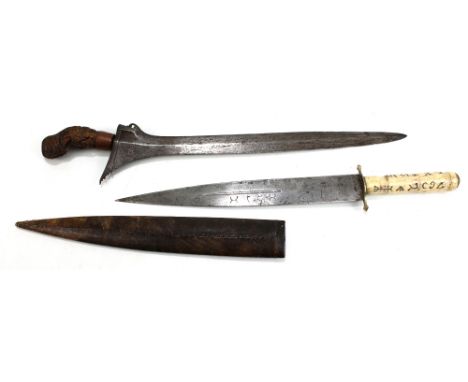 An Indonesian kris with carved wooden grip, length of blade 38cm (lacking scabbard), and a Middle Eastern (probably) bone han