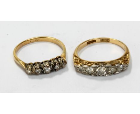 Two 18ct yellow gold diamond five stone rings, one with high scroll decorated bead setting with central stone measuring appro