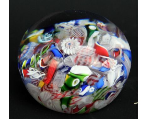 A Baccarat clear glass scrambled latticino and millefiori decorated paperweight, diameter 4.5cm. CONDITION REPORT: Very light