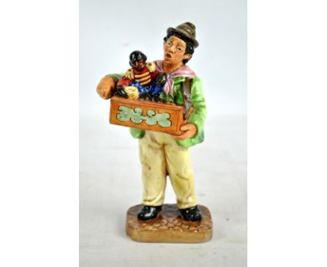 A Royal Doulton figure; HN2173 'Organ Grinder', height 22.5cm. CONDITION REPORT: Some light surface pitting but in good condi