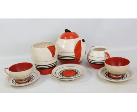 A Susie Cooper design 'Kestrel' shape part tea set comprising a teapot, a milk jug, a twin handled sugar bowl (lid missing), 