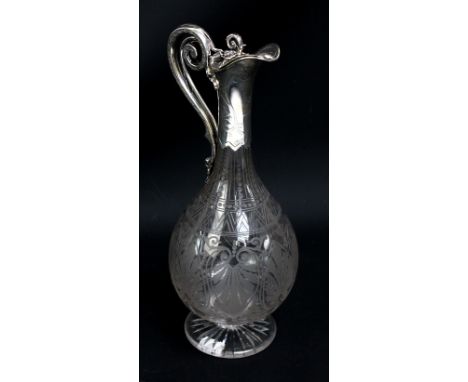 JAMES CHARLES EDDINGTON; a Victorian hallmarked silver mounted clear glass bottle shaped footed claret jug engraved with acro