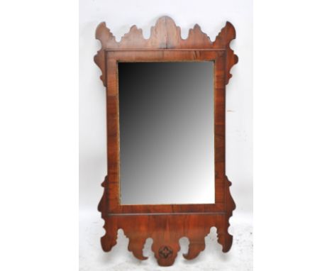 An early 20th century Chippendale style walnut fretwork framed mirror, height 92cm.