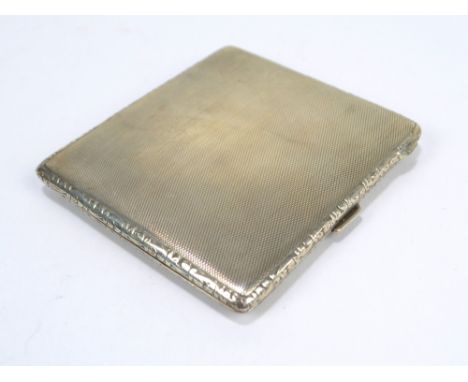 CHARLES S GREEN & CO LTD; a George VI hallmarked silver rectangular overall engine turned decorated cigarette case, Birmingha