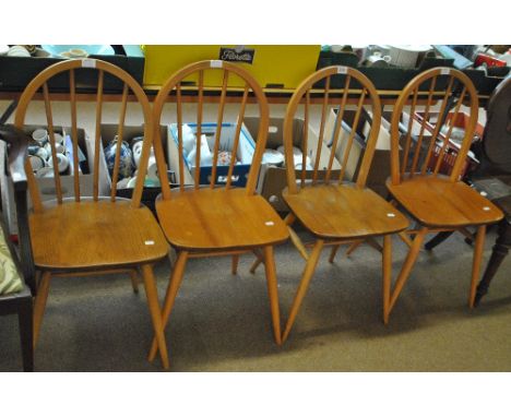 ERCOL; a set of four light elm hoop back kitchen chairs.