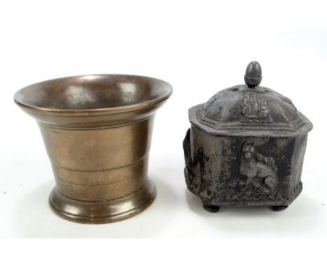 An 18th century lead tobacco jar decorated with a dog and birds beneath acorn finial and raised on four scrolling feet, width