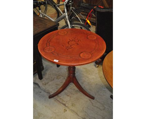 A mahogany tripod occasional table with engraved leatherette top, diameter 69cm.