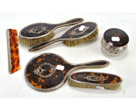 HASSET & HARPER LTD; a George V hallmarked silver and tortoiseshell backed four piece dressing table set with pique work, eac