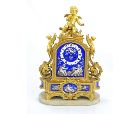 A 19th century French ormolu mantel clock with cherubic finial and winged nudes to shoulders above foliate scrolls, the paint