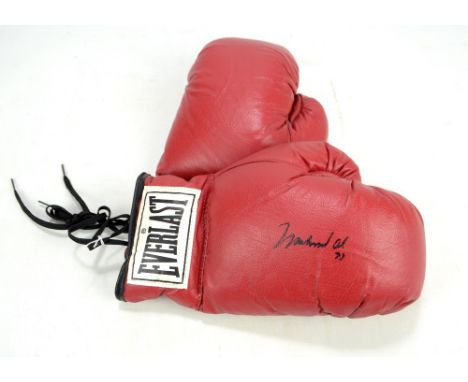 MUHAMMAD ALI; a pair of Everlast boxing gloves, one signed and indistinctly dated, with certificate of authenticity from Sout