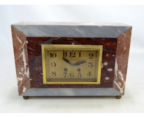 An early 20th century marble cased eight day striking mantel clock, the brass dial set with Arabic numerals, inscribed 'A Guy