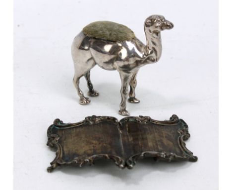 ADIE & LOVEKIN LTD; an Edward VII hallmarked silver pin cushion modelled as a camel, Birmingham 1906, length 7cm, and an engi