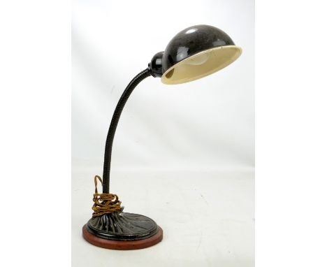 A 1930s table lamp with painted domed cover and cast iron oval base.