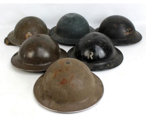 Six WWII period Brodie-type helmets including brown example with National Fire Service decal and numbered 29, a black helmet 