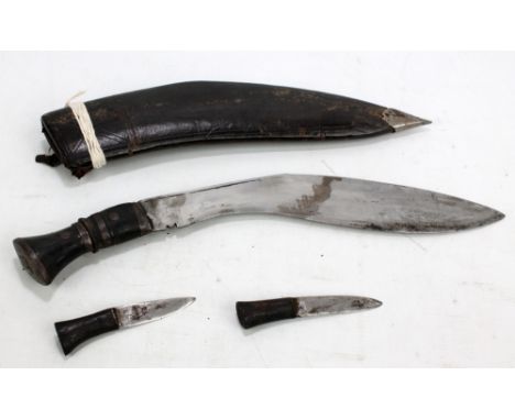 A horn handled kukri with karda and chakmak in leather scabbard. CONDITION REPORT: All heavily worn. 