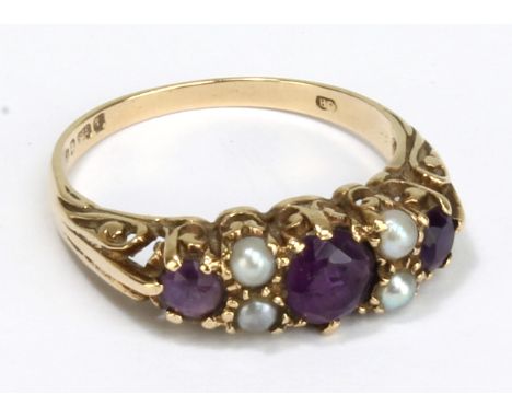 A 9ct yellow gold Victorian style amethyst and seed pearl ring in high scroll decorated claw setting, size R, approx 3.1g.