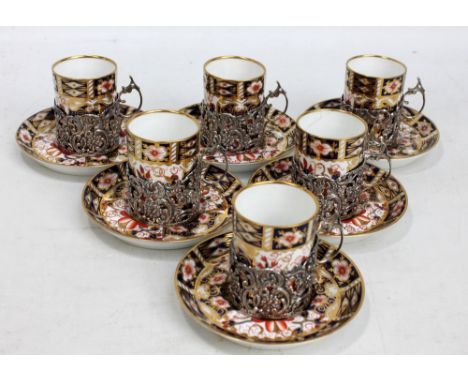 A set of six Royal Crown Derby Imari pattern decorated coffee cans and saucers, number 2451B, the cups with foliate scroll pi