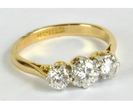 An 18ct yellow gold three stone diamond ring, the central stone measuring approx 0.5ct, further stones approx 0.25ct in plati