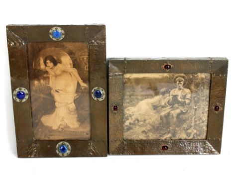 Two Arts and Crafts style rectangular beaten copper photo frames, the larger set with blue ceramic roundels, the smaller with