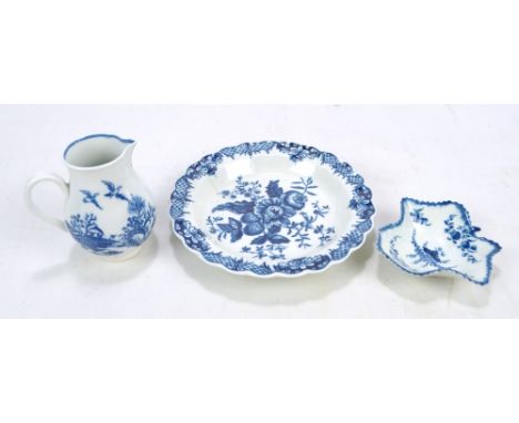 An 18th century Worcester porcelain shaped circular plate painted in underglaze blue with floral and fruit sprays within orna