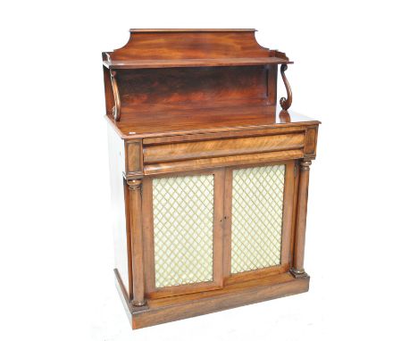 An early 19th century mahogany chiffonier with raised back and shelf on S-scroll supports above frieze drawer and pair of sil