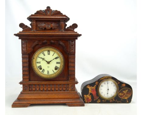 An early 20th century oak cased eight day mantel clock set with Roman numerals, height 46cm and a further ebonised example wi